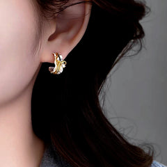 Close-up detail of the sparkling zircons and plating on the Bow Hoop Earrings