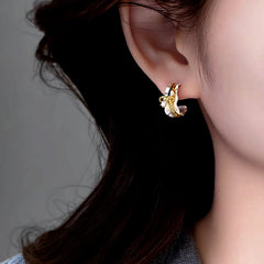 Model showcasing the dangle and style of the 14K Gold-Plated Elegant Zircon Bow C-Shaped Earrings