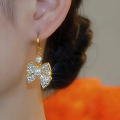 Close-up detail of the sparkling zircons and plating on the Zircon Bow Earrings