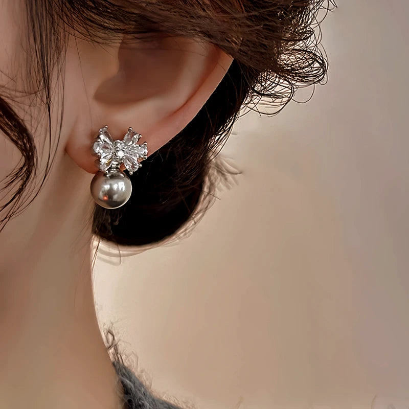 Angled view of the 14K Gold-Plated Elegant Zircon Bow Pearl Earrings