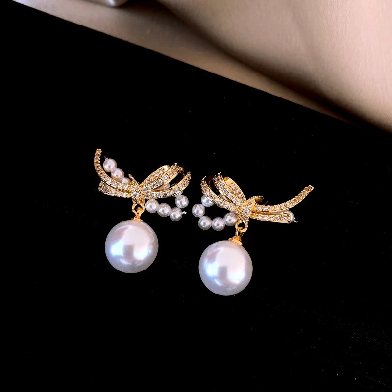 Close-up detail of the sparkling zircons and plating on the Bow Pearl Earrings
