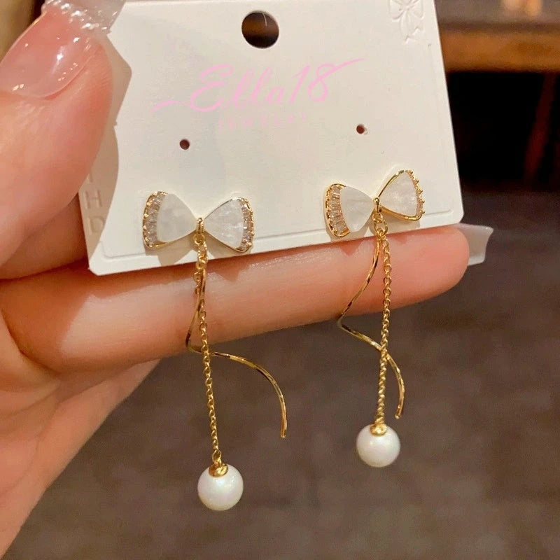 Angled view of the 14K Gold-Plated Elegant Zircon Bow Pearl Tassel Earrings