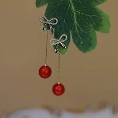 Angled view of the 14K Gold-Plated Elegant Zircon Bow Red Pearl Tassel Earrings