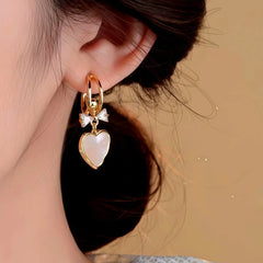 Close-up detail of the sparkling zircons and plating on the Shell Heart Earrings