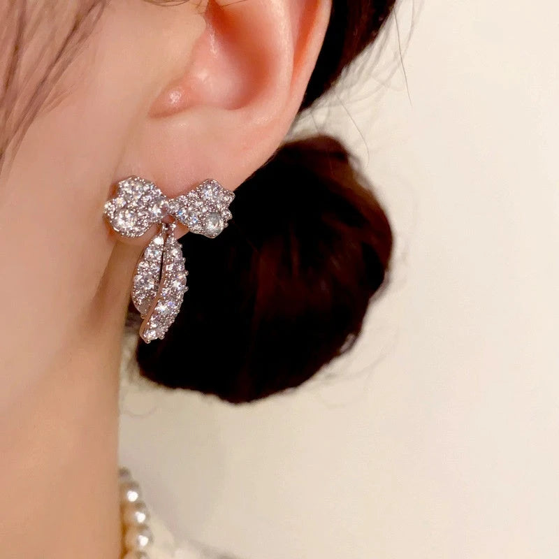 Angled view of the 14K Gold-Plated Elegant Zircon Bow Tassel Earrings