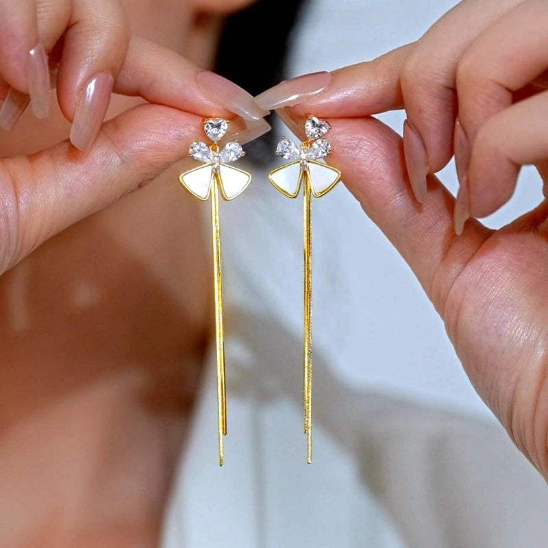 Angled view of the 14K Gold-Plated Elegant Zircon Bow Tassel Earrings