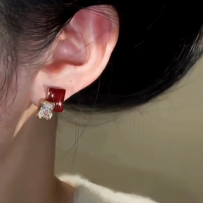 Close-up detail of the sparkling zircons and plating on the Burgundy Stud Earrings