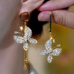 Model showcasing the dangle and style of the 14K Gold-Plated Elegant Zircon Butterfly Asymmetrical Earrings