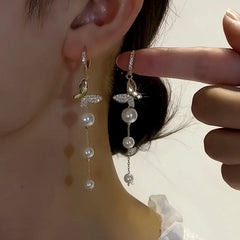 Model showcasing the dangle and style of the 14K Gold-Plated Elegant Zircon Butterfly Pearl Tassel Earrings