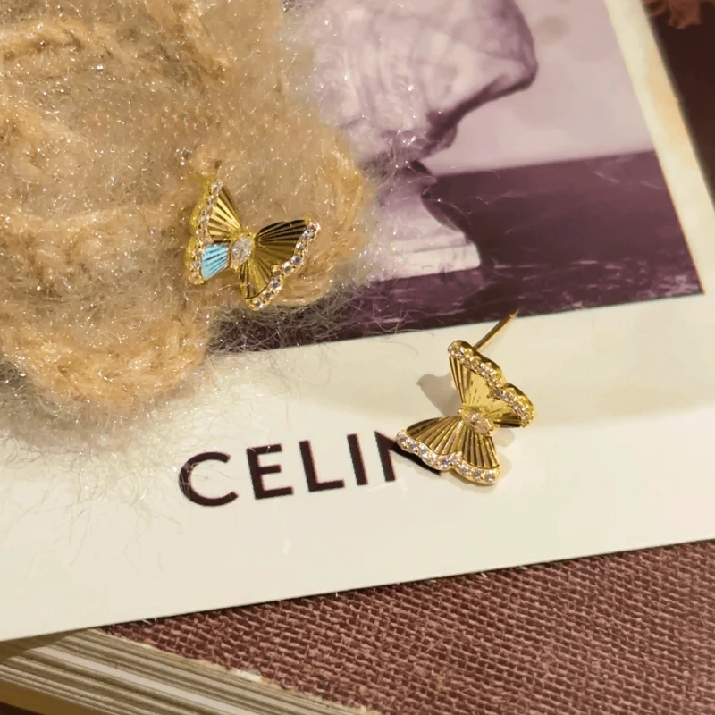 Model showcasing the dangle and style of the 14K Gold-Plated Elegant Zircon Butterfly Studs