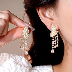 Model showcasing the dangle and style of the 14K Gold-Plated Elegant Zircon Butterfly Tassel Earrings