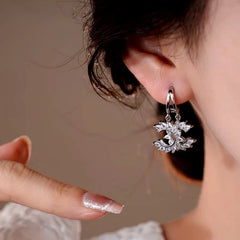 Model showcasing the dangle and style of the 14K Gold-Plated Elegant Zircon C-Shaped Earrings