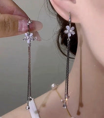 Model showcasing the dangle and style of the 14K Gold-Plated Elegant Zircon Cat's Eye Flower Ear Hook Earrings