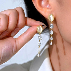 Model showcasing the dangle and style of the 14K Gold-Plated Elegant Zircon Cat's Eye Stone Earrings
