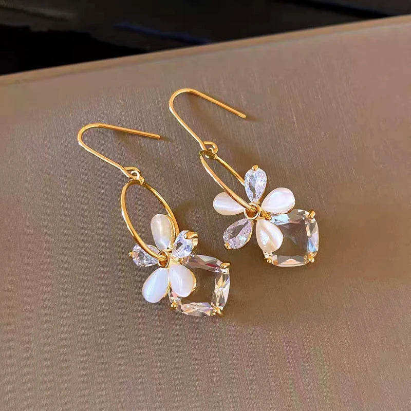 Angled view of the 14K Gold-Plated Elegant Zircon Cat's Eye Stone Flower Ear Hook Earrings