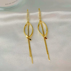 Angled view of the 14K Gold-Plated Elegant Zircon Cross Tassel Earrings