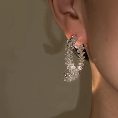 Model showcasing the dangle and style of the 14K Gold-Plated Elegant Zircon Crystal Cross Earrings