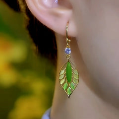 Model showcasing the dangle and style of the 14K Gold-Plated Elegant Zircon Crystal Leaf Earrings