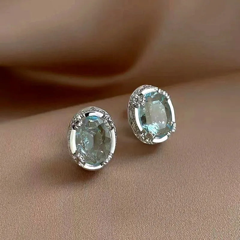 Model showcasing the dangle and style of the 14K Gold-Plated Elegant Zircon Crystal Stud Earrings