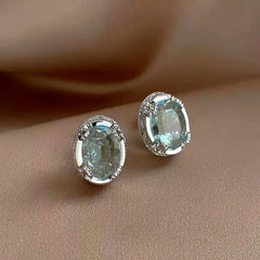 Model showcasing the dangle and style of the 14K Gold-Plated Elegant Zircon Crystal Stud Earrings