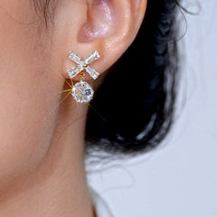 Model showcasing the dangle and style of the 14K Gold-Plated Elegant Zircon Diamond Bow Ball Earrings