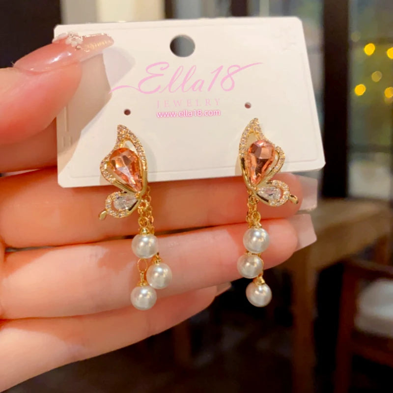 Model showcasing the dangle and style of the 14K Gold-Plated Elegant Zircon Diamond Butterfly Pearl Tassel Earrings