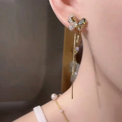 Model showcasing the dangle and style of the 14K Gold-Plated Elegant Zircon Diamond Butterfly Tassel Earrings