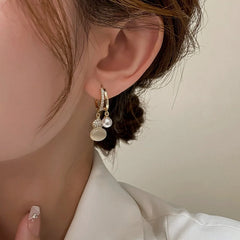 Model showcasing the dangle and style of the 14K Gold-Plated Elegant Zircon Diamond Cat's Eye Stone Gourd Earrings