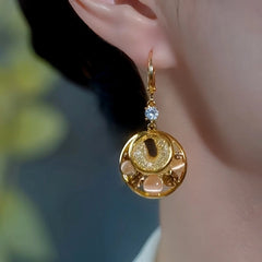 Model showcasing the dangle and style of the 14K Gold-Plated Elegant Zircon Diamond Cat's Eye Stone Water Drop Earrings