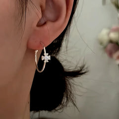 Angled view of the 14K Gold-Plated Elegant Zircon Diamond Cross Hoop Earrings