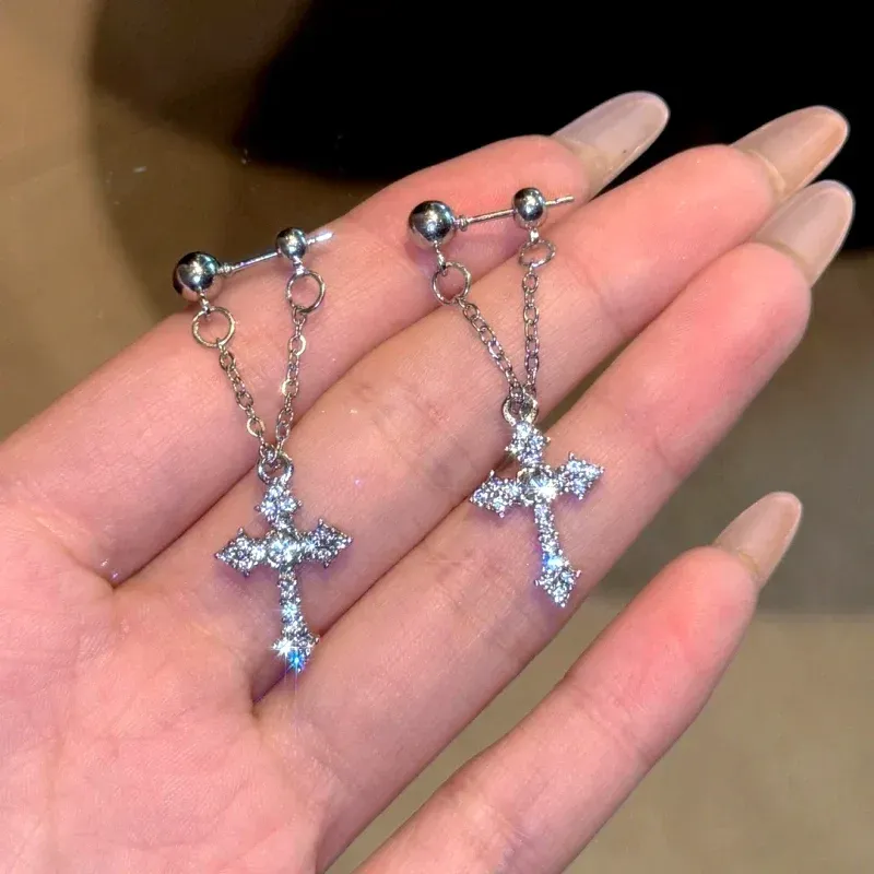 Model showcasing the dangle and style of the 14K Gold-Plated Elegant Zircon Diamond Cross Tassel Earrings