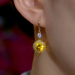 Model showcasing the dangle and style of the 14K Gold-Plated Elegant Zircon Diamond Earrings