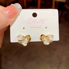 Model showcasing the dangle and style of the 14K Gold-Plated Elegant Zircon Diamond Flower Heart Stud Earrings