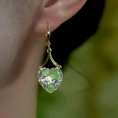 Model showcasing the dangle and style of the 14K Gold-Plated Elegant Zircon Diamond Green Cat's Eye Stone Heart Earrings