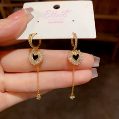 Angled view of the 14K Gold-Plated Elegant Zircon Diamond Heart Tassel Earrings