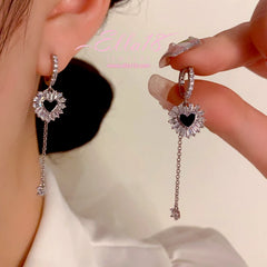 Model showcasing the dangle and style of the 14K Gold-Plated Elegant Zircon Diamond Heart Tassel Earrings