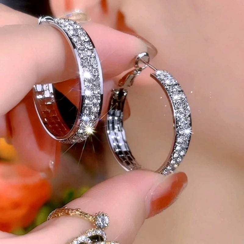 Model showcasing the dangle and style of the 14K Gold-Plated Elegant Zircon Diamond Hoop Earrings