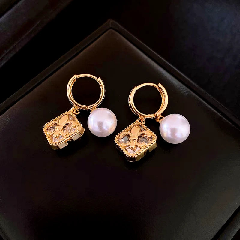 Angled view of the 14K Gold-Plated Elegant Zircon Diamond Iris Pearl Earrings