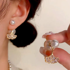 Model showcasing the dangle and style of the 14K Gold-Plated Elegant Zircon Diamond Leaf Pearl Jacket Earrings