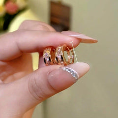 Model showcasing the dangle and style of the 14K Gold-Plated Elegant Zircon Diamond Little Hoop Earrings