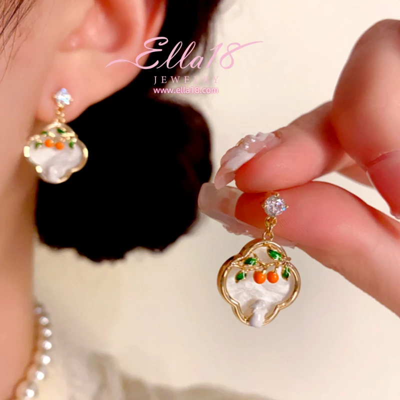 Close-up detail of the sparkling zircons and plating on the Persimmon Earrings