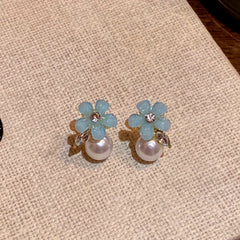 Close-up detail of the sparkling zircons and plating on the Blue Flower Studs