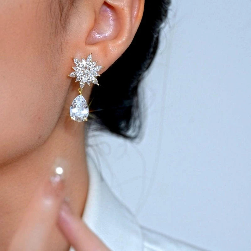 Model showcasing the dangle and style of the 14K Gold-Plated Elegant Zircon Diamond Petal Flower Water Drop Earrings