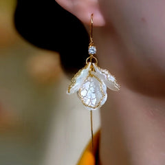 Close-up detail of the sparkling zircons and plating on the Shell Threader Earrings