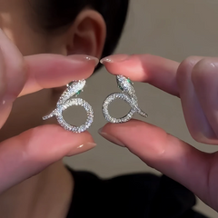 Close-up detail of the sparkling zircons and plating on the Snake Earrings