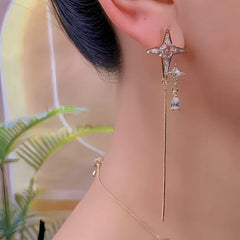 Model showcasing the dangle and style of the 14K Gold-Plated Elegant Zircon Diamond Star Tassel Earrings