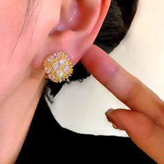 Model showcasing the dangle and style of the 14K Gold-Plated Elegant Zircon Diamond Stud Earrings