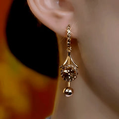 Model showcasing the dangle and style of the 14K Gold-Plated Elegant Zircon Diamond Tassel Earrings
