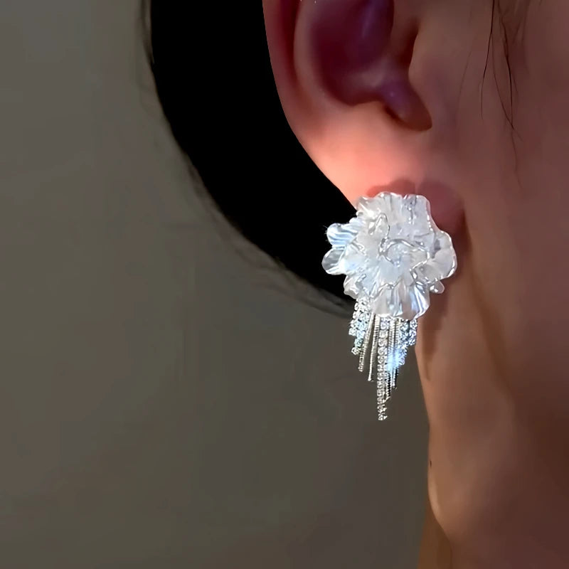 Model showcasing the dangle and style of the 14K Gold-Plated Elegant Zircon Diamond White Camellia Earrings