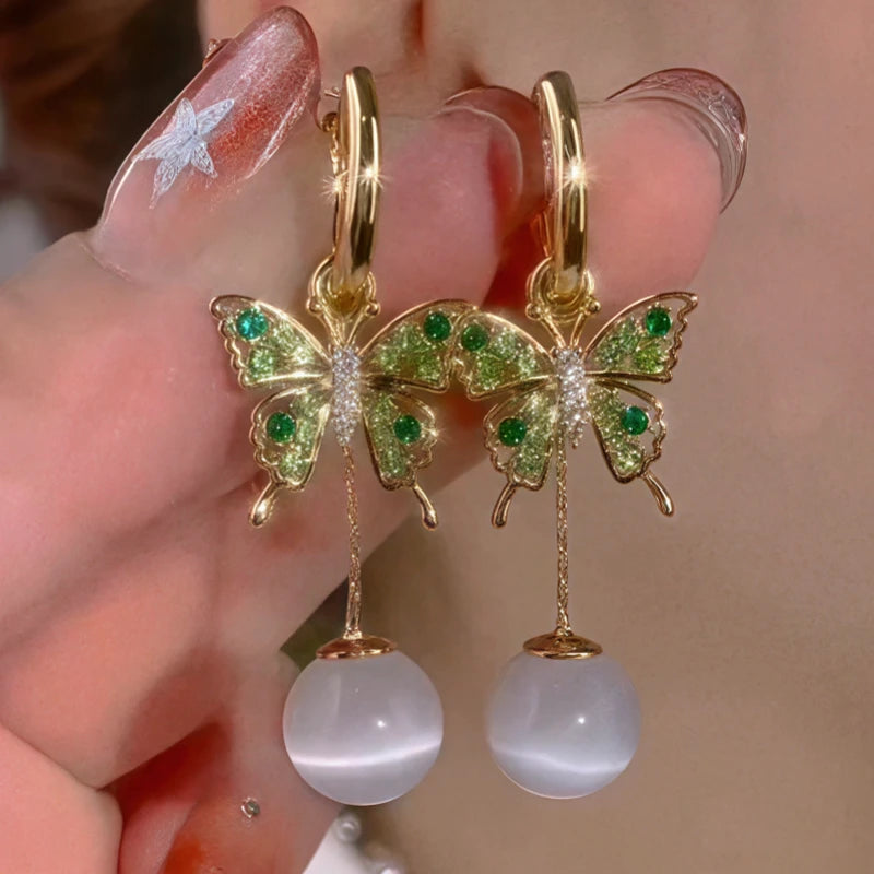 Model showcasing the dangle and style of the 14K Gold-Plated Elegant Zircon Diiamond Butterfly Cat's Eye Stone Earrings